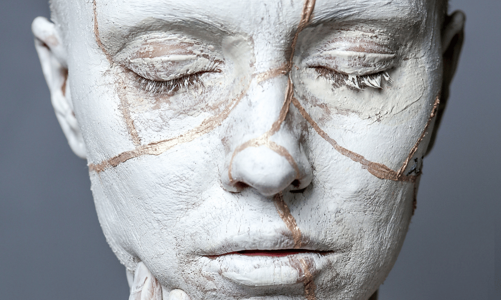 persona con pintura blanca en la cara, primer plano. ilustrativa: Kintsugi. como filosofía de vida, cosmovisión, ayuda espiritual