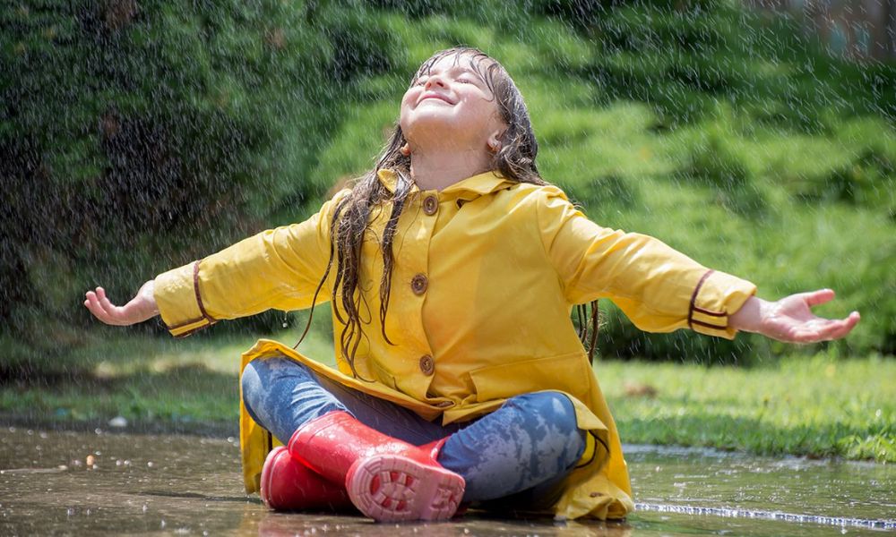 Niña disfrutando de la lluvia